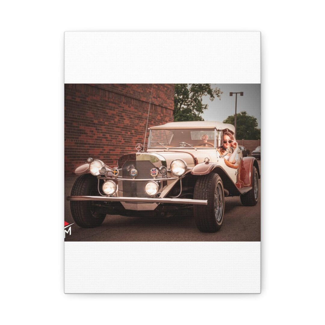 Classic vintage car parked near a brick wall.