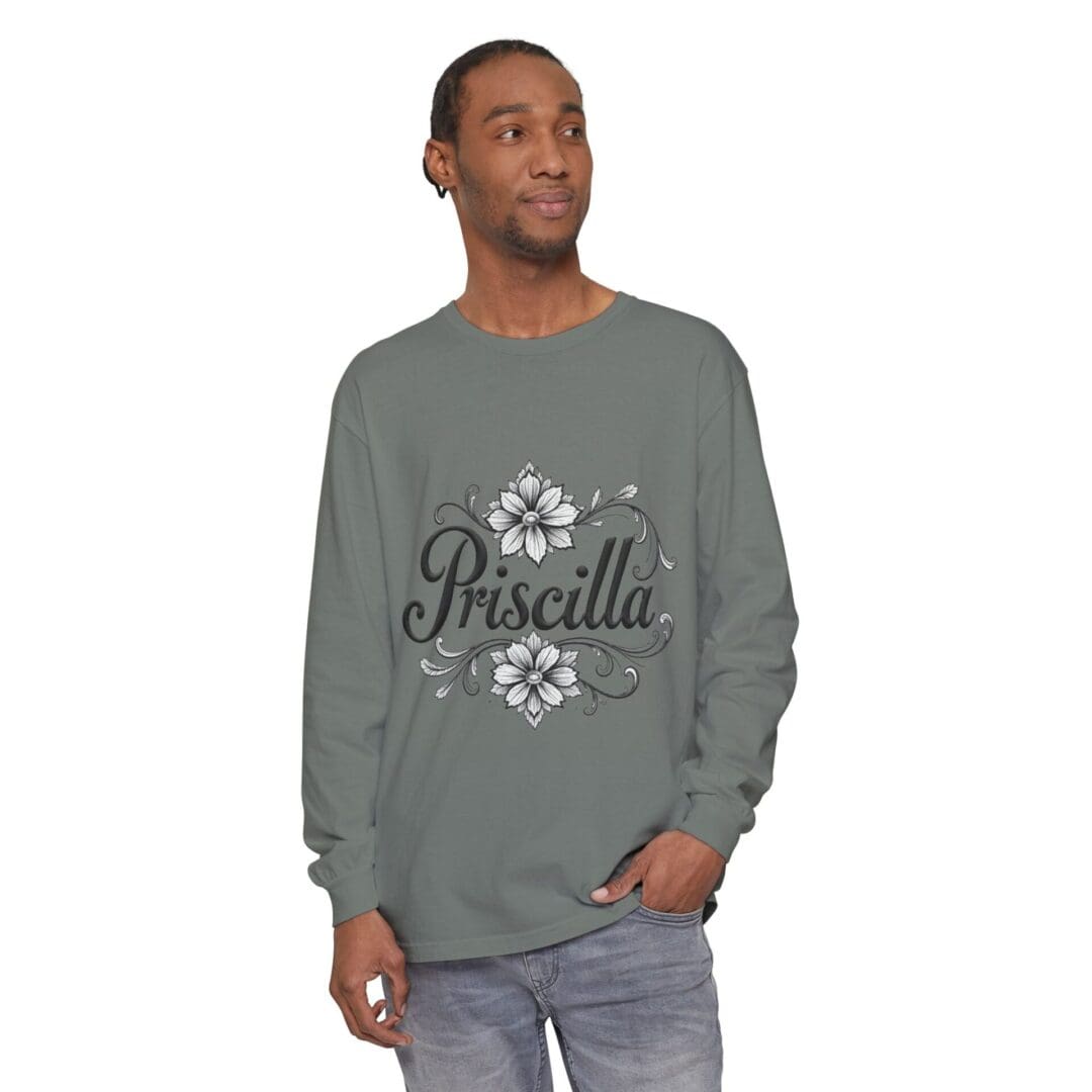 Man wearing a gray long-sleeve shirt with floral design and 'Priscilla' text.