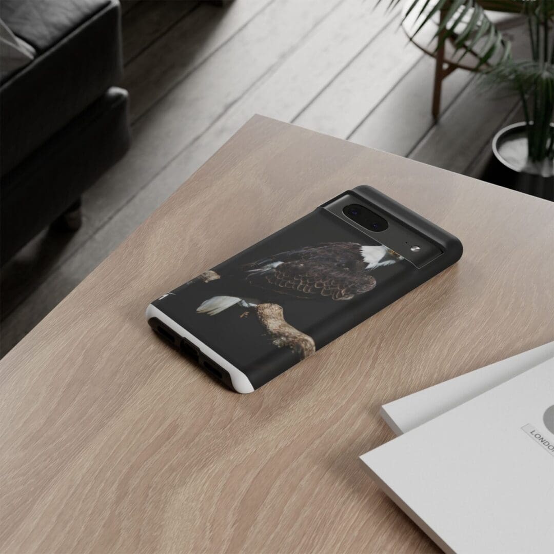 Black marble phone case on a wooden table.
