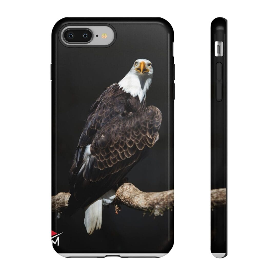 Phone case featuring a detailed bald eagle perched on a branch against a black background.