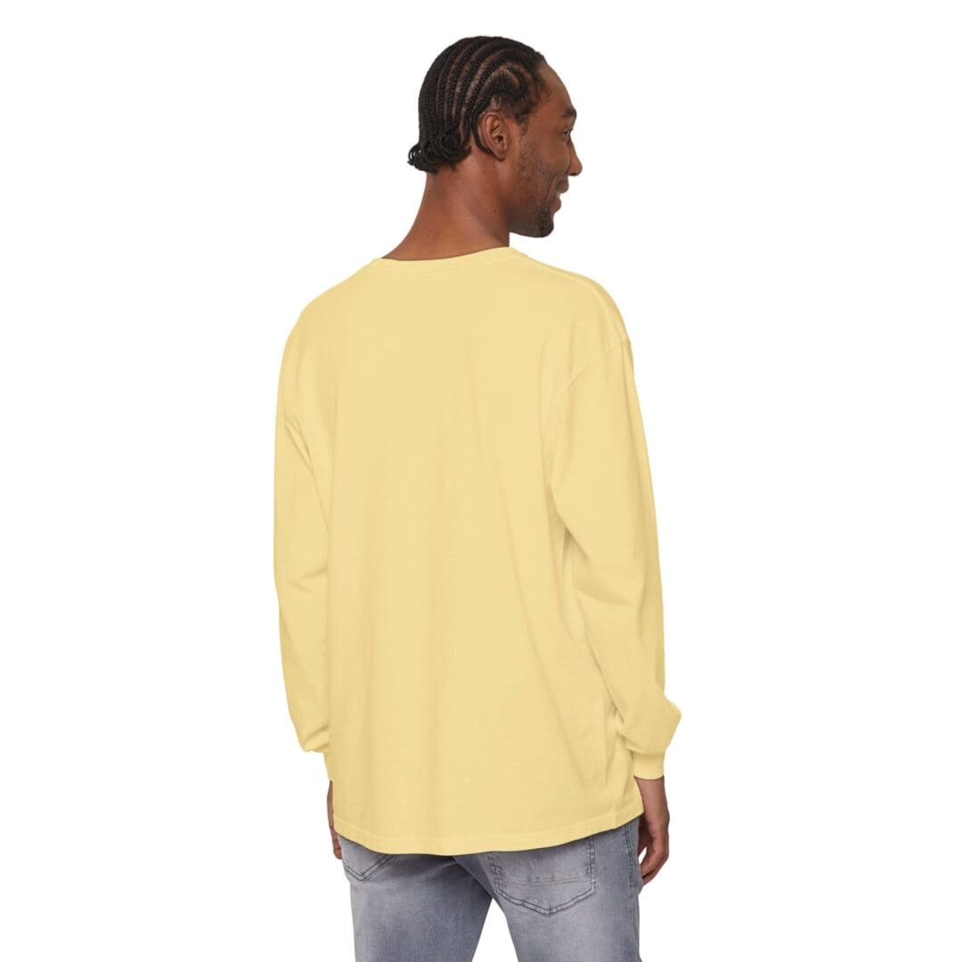 Rear view of a person wearing a yellow long-sleeve shirt and jeans.
