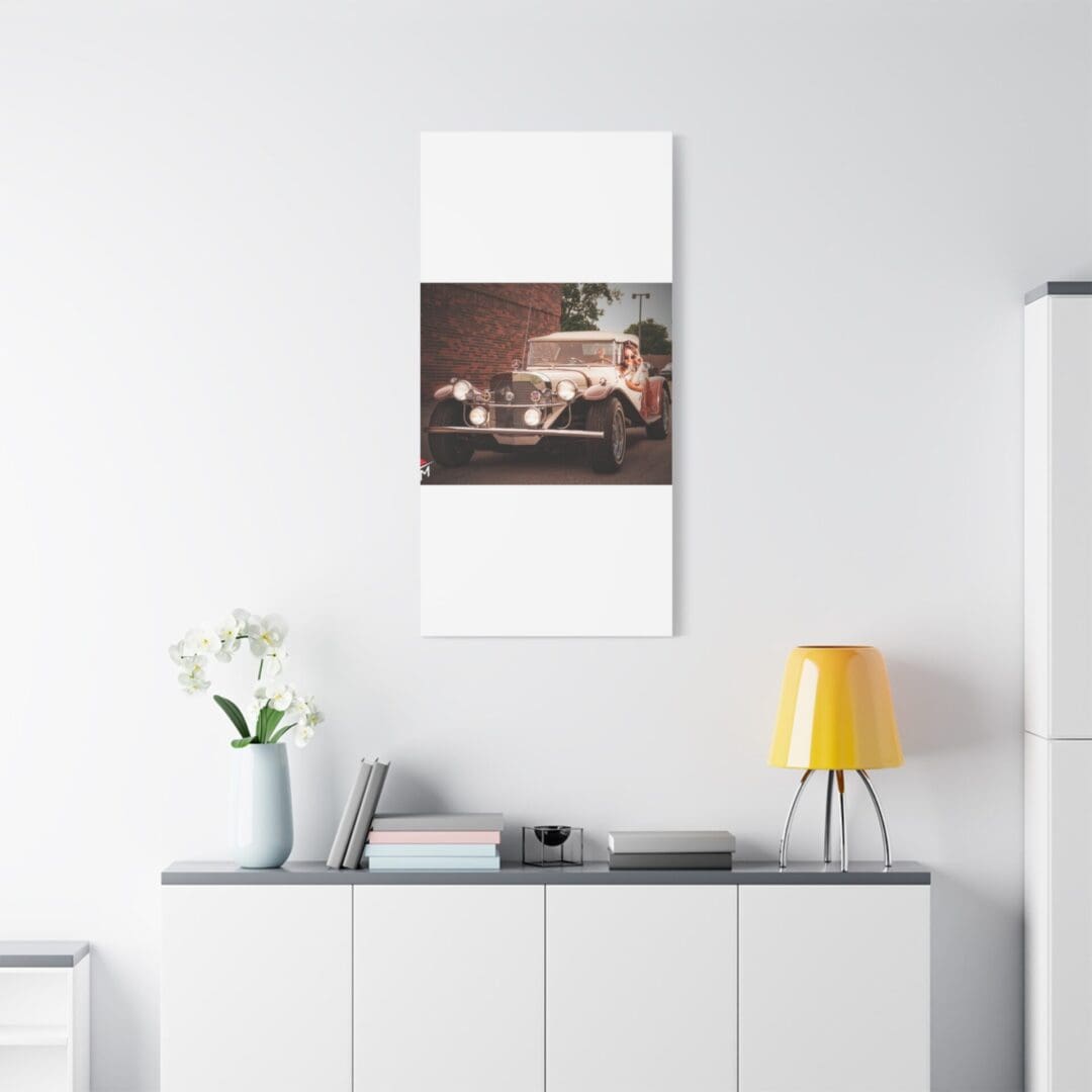 Minimalist interior with a white sideboard, yellow lamp, and a framed photo on the wall.