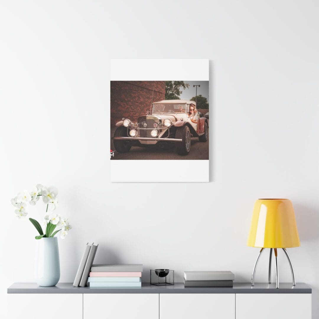 A cozy modern shelf with a vintage car photograph and decorative items.