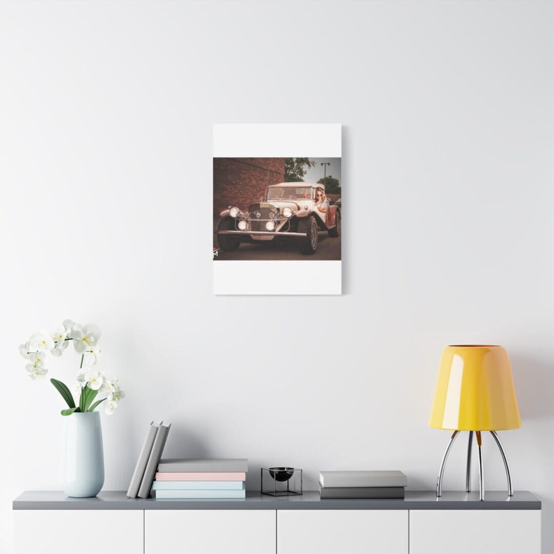 Minimalist shelf with a yellow lamp, plant, and framed photo on a white wall.