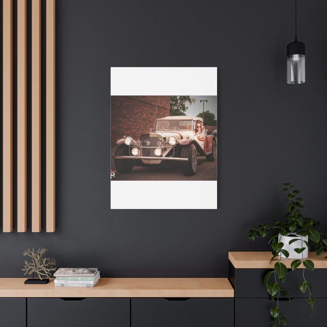 Vintage car artwork on dark wall above modern desk setup.