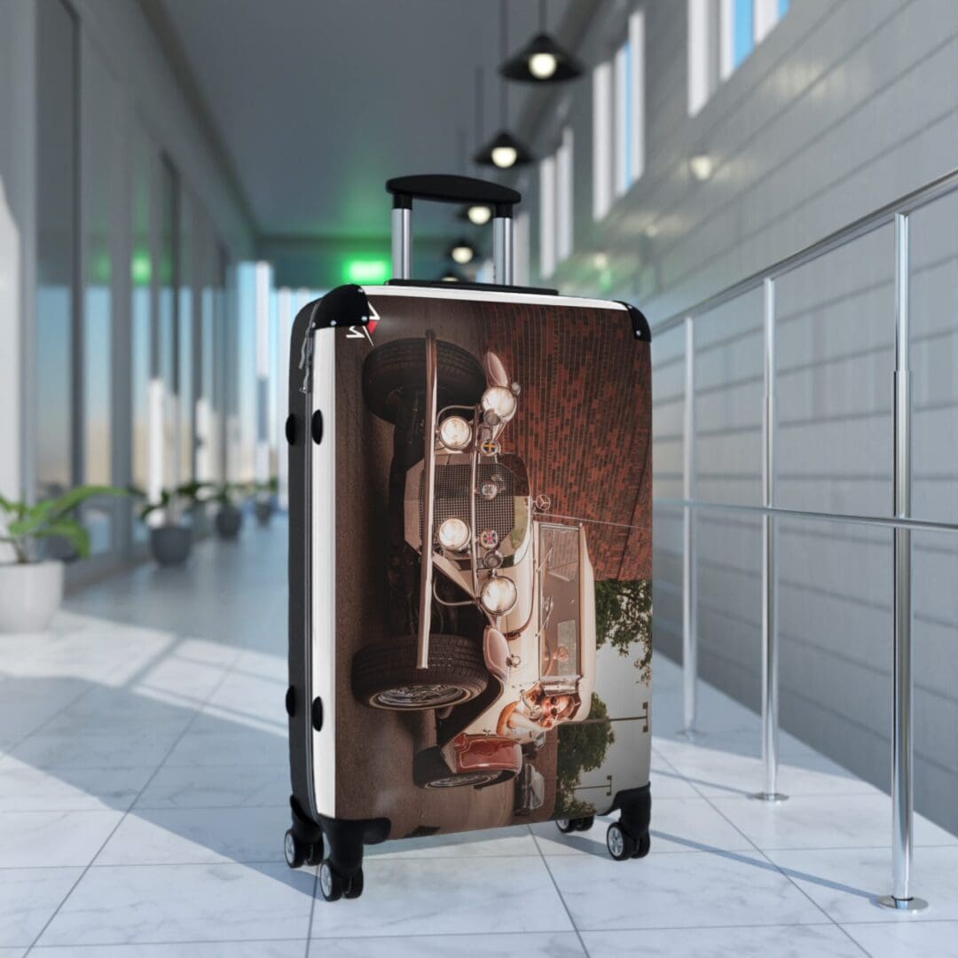 A stylish suitcase with a vintage car design in a modern airport terminal.
