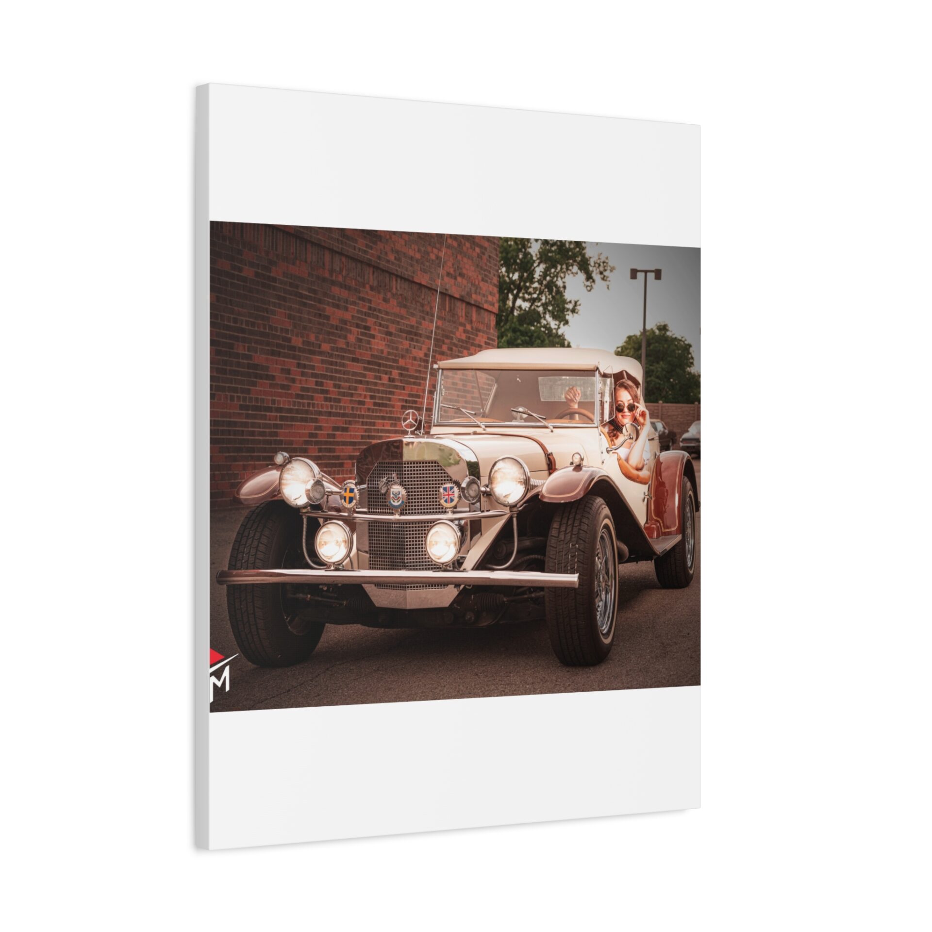 Vintage car parked near a brick wall with greenery.