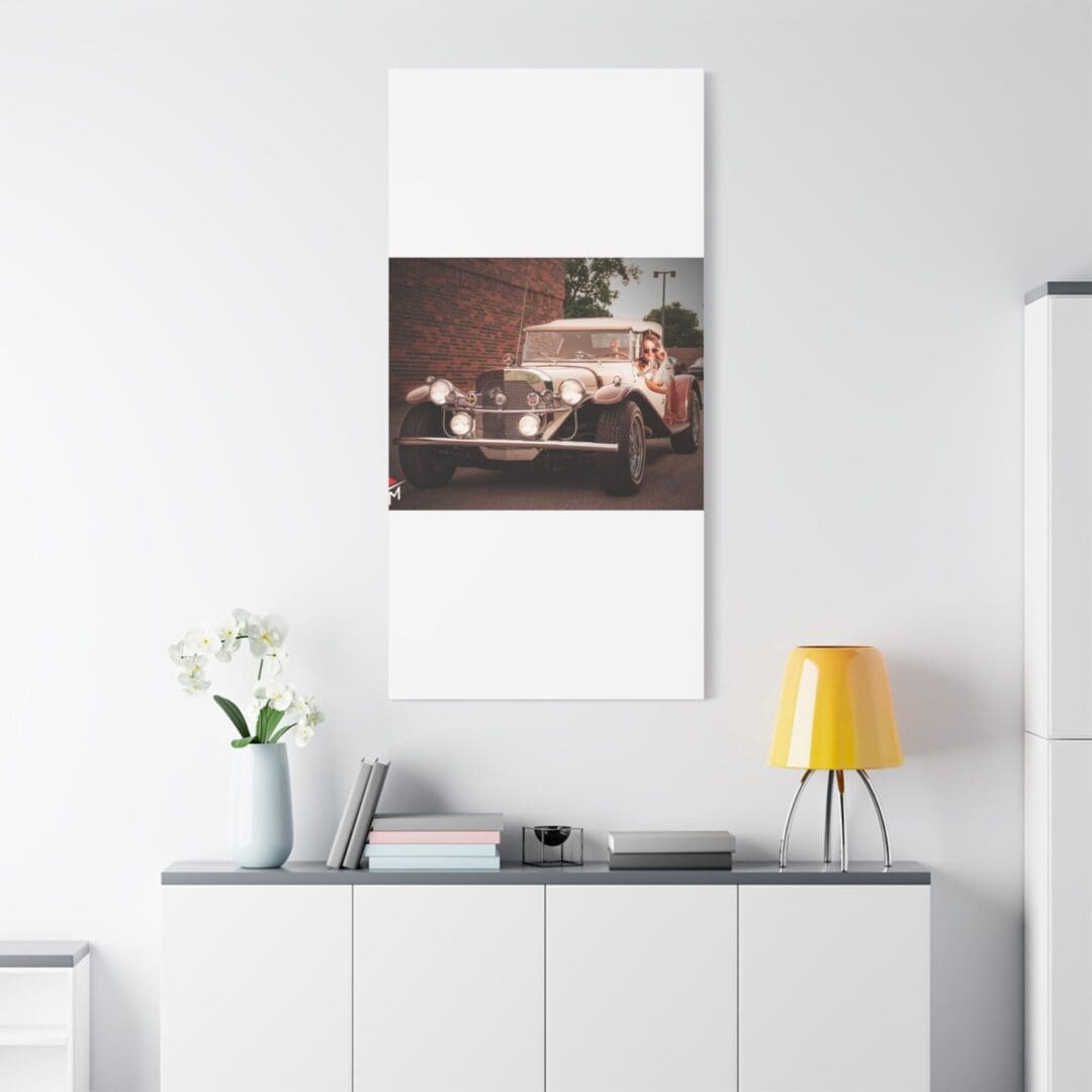Modern living room with a stylish car poster above a white sideboard.