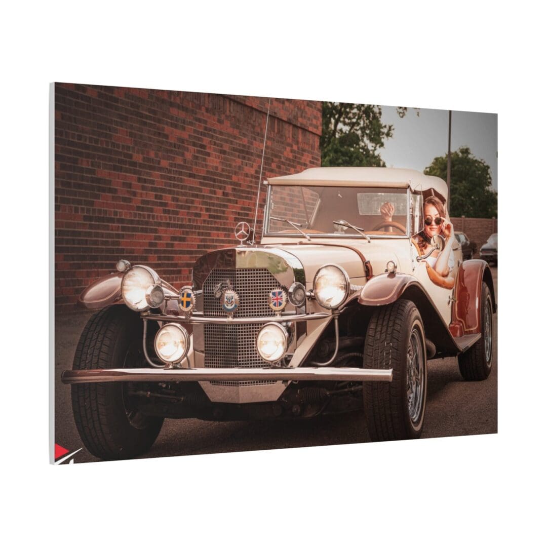 Vintage car parked beside a brick wall on a sunny day.