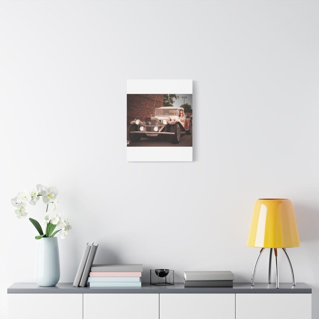 Minimalist room with a white sideboard, yellow lamp, and a framed picture on the wall.