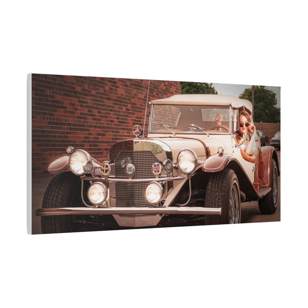 A vintage car parked in front of a brick wall.