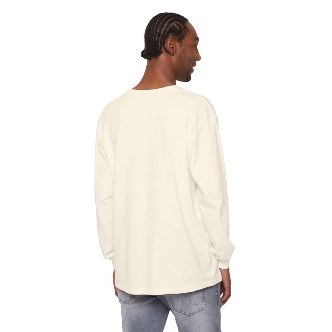 Man wearing a cream long-sleeve shirt and jeans, facing away.
