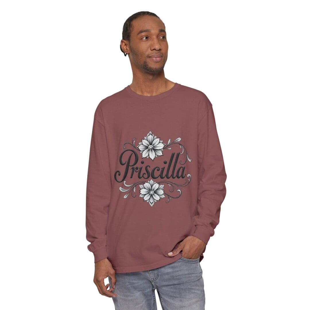 Man wearing a maroon sweatshirt with floral and script design.
