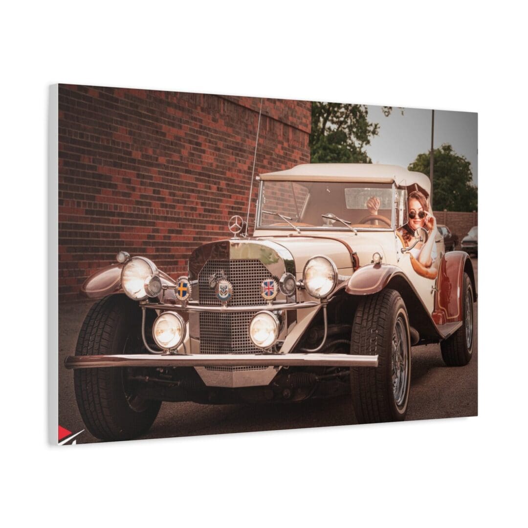 Vintage car with a woman in a white dress sitting on the door.
