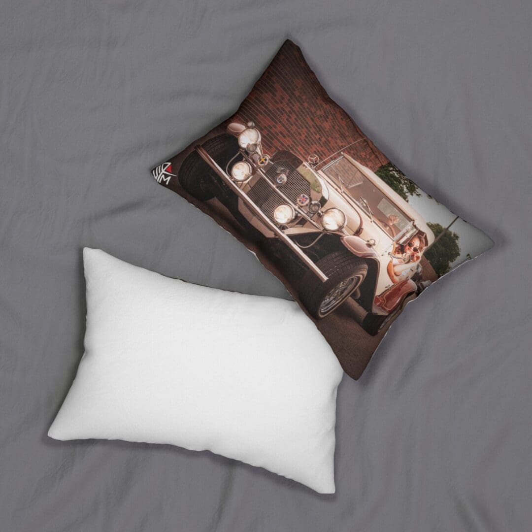 Two pillows, one plain white and one with a vintage car print, on a gray surface.