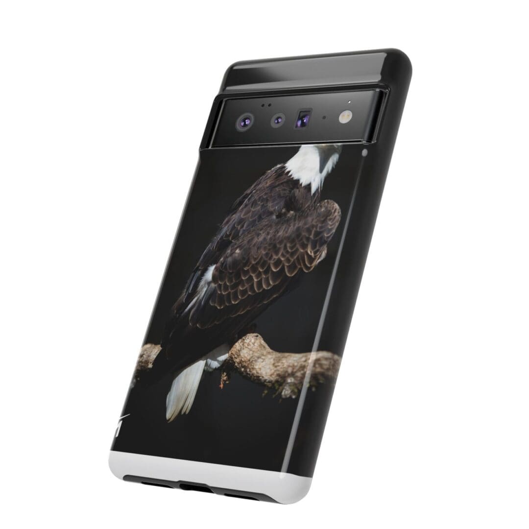 A smartphone displaying a dark-themed image of a person on its screen.