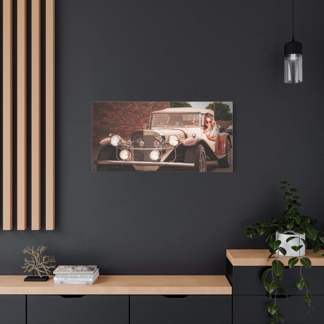Vintage car photo on a dark wall above a wooden desk with plants and decor.