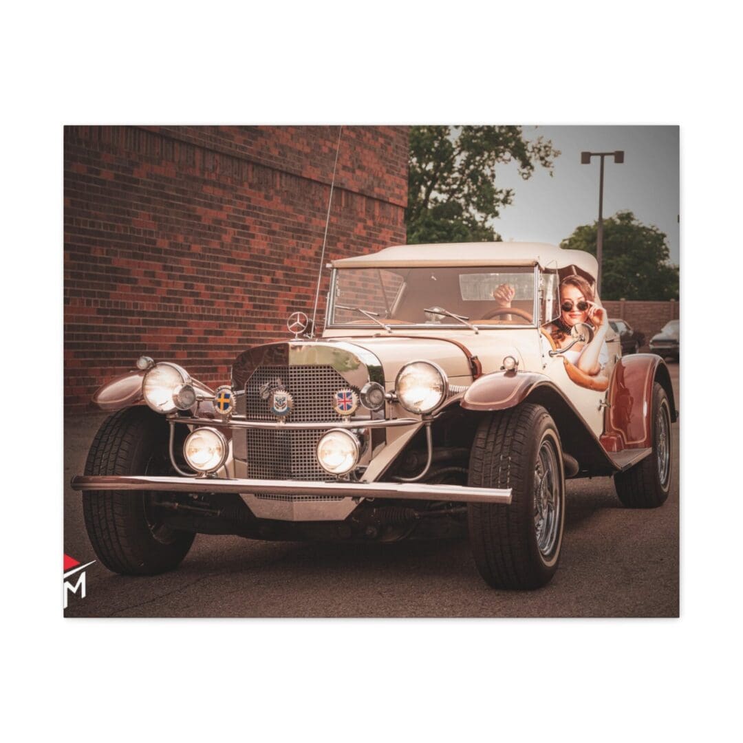 Vintage car driving down a street with a person inside.