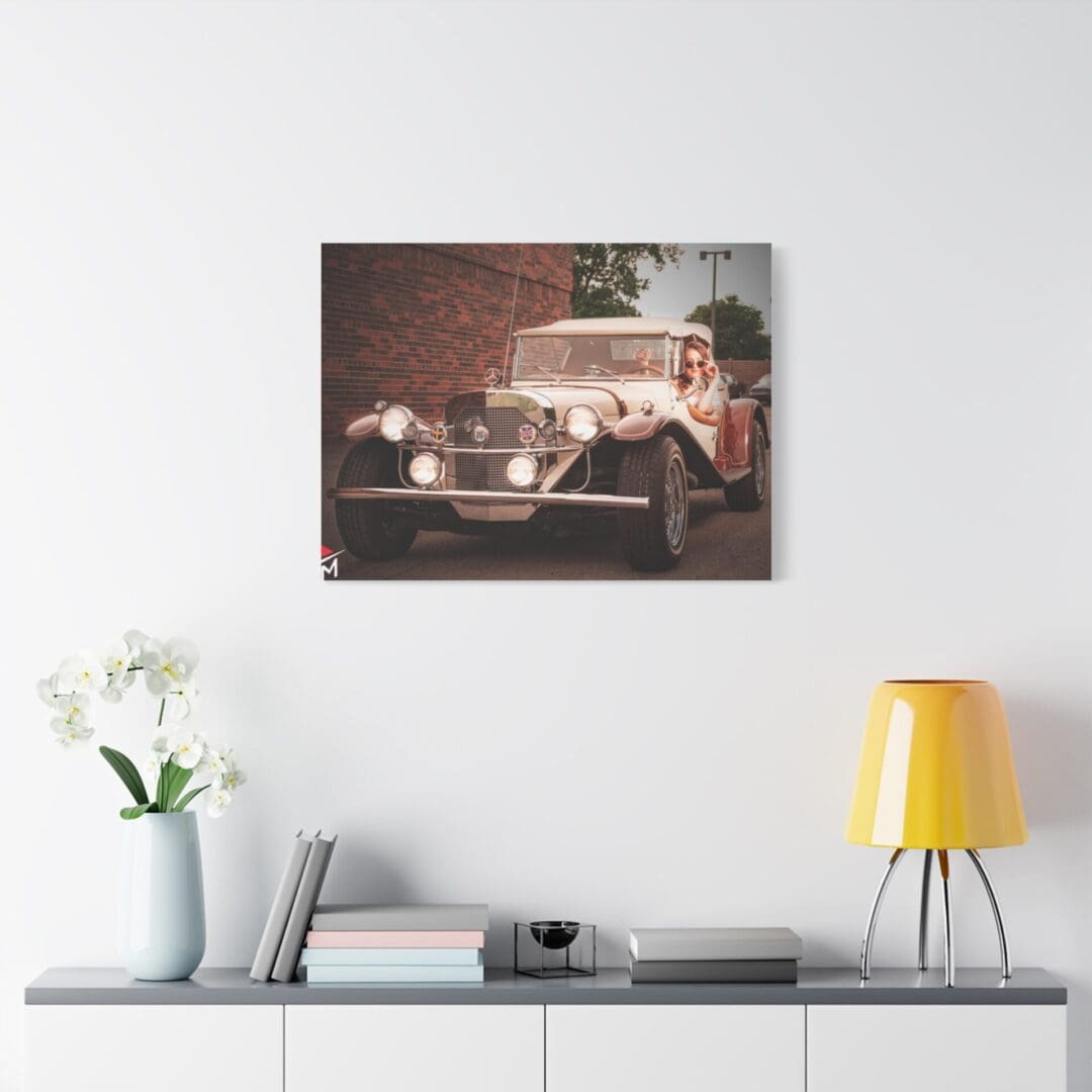 Vintage race car speeding on a track, framed and hanging on a white wall.