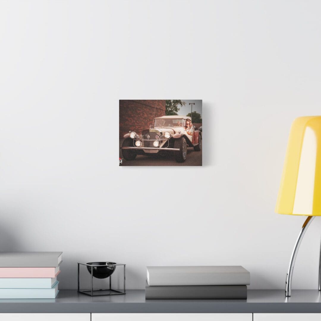 Modern living room featuring a vintage car photo above a minimalist console and a yellow lamp.