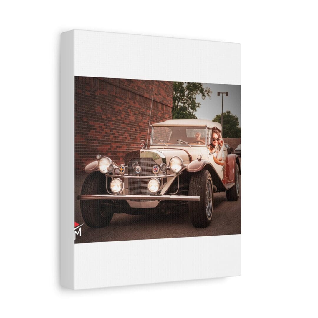 Vintage car parked near a brick wall with greenery in the background.