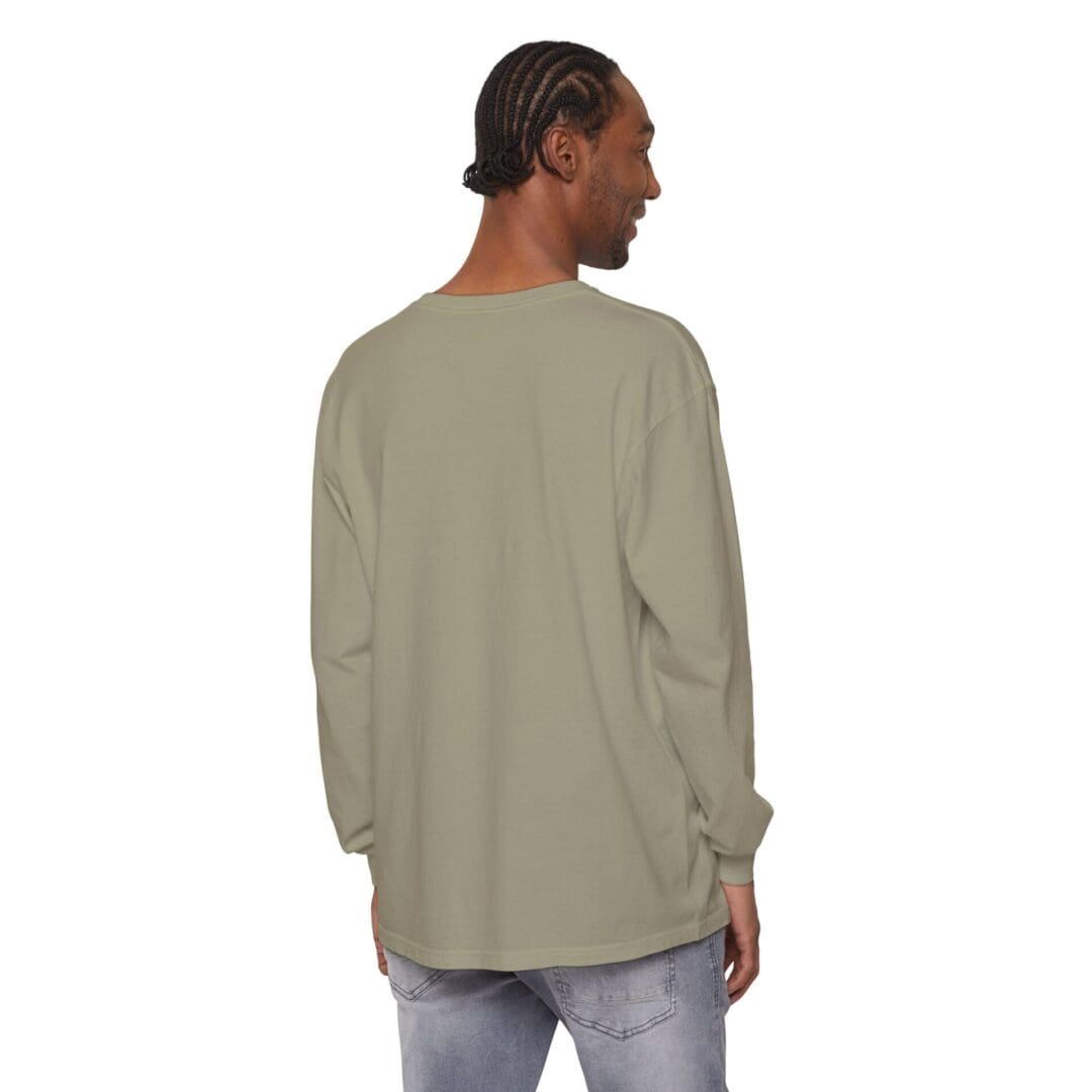 Man wearing a loose, light olive green long-sleeve shirt, seen from the back.
