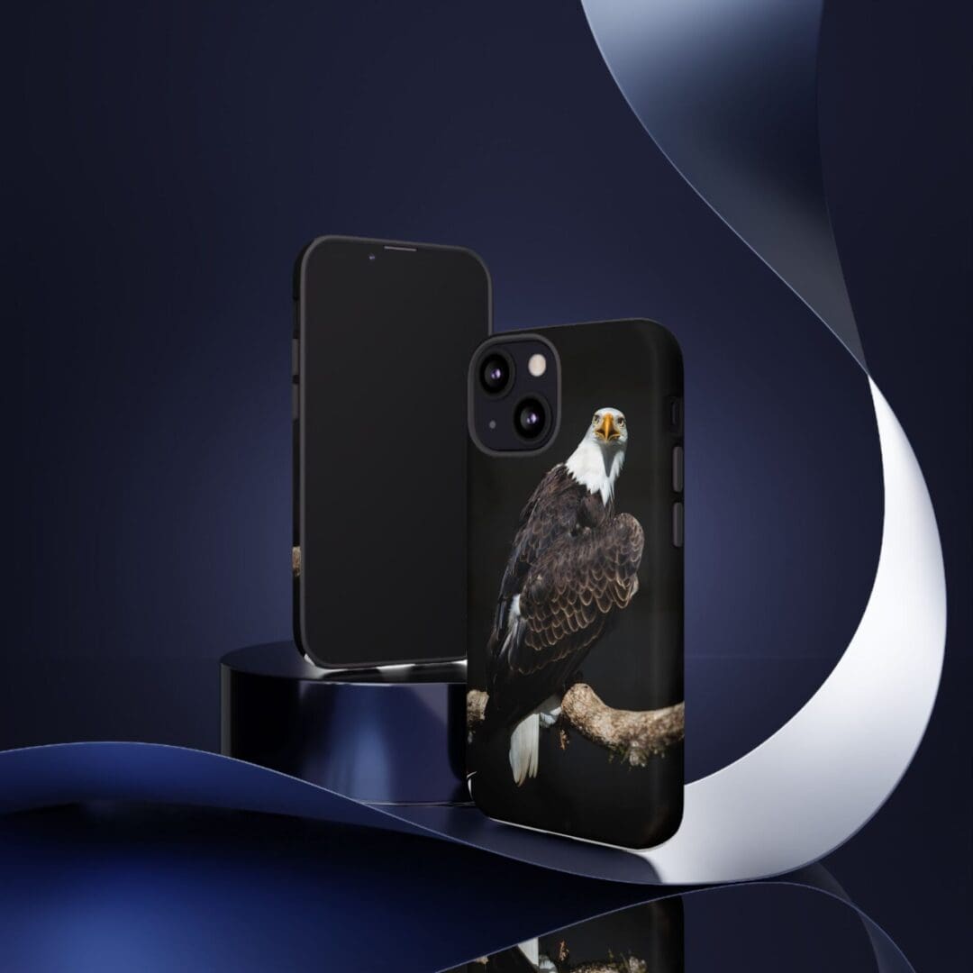 A sleek black smartphone with a unique artistic phone case featuring a dark, mysterious figure.
