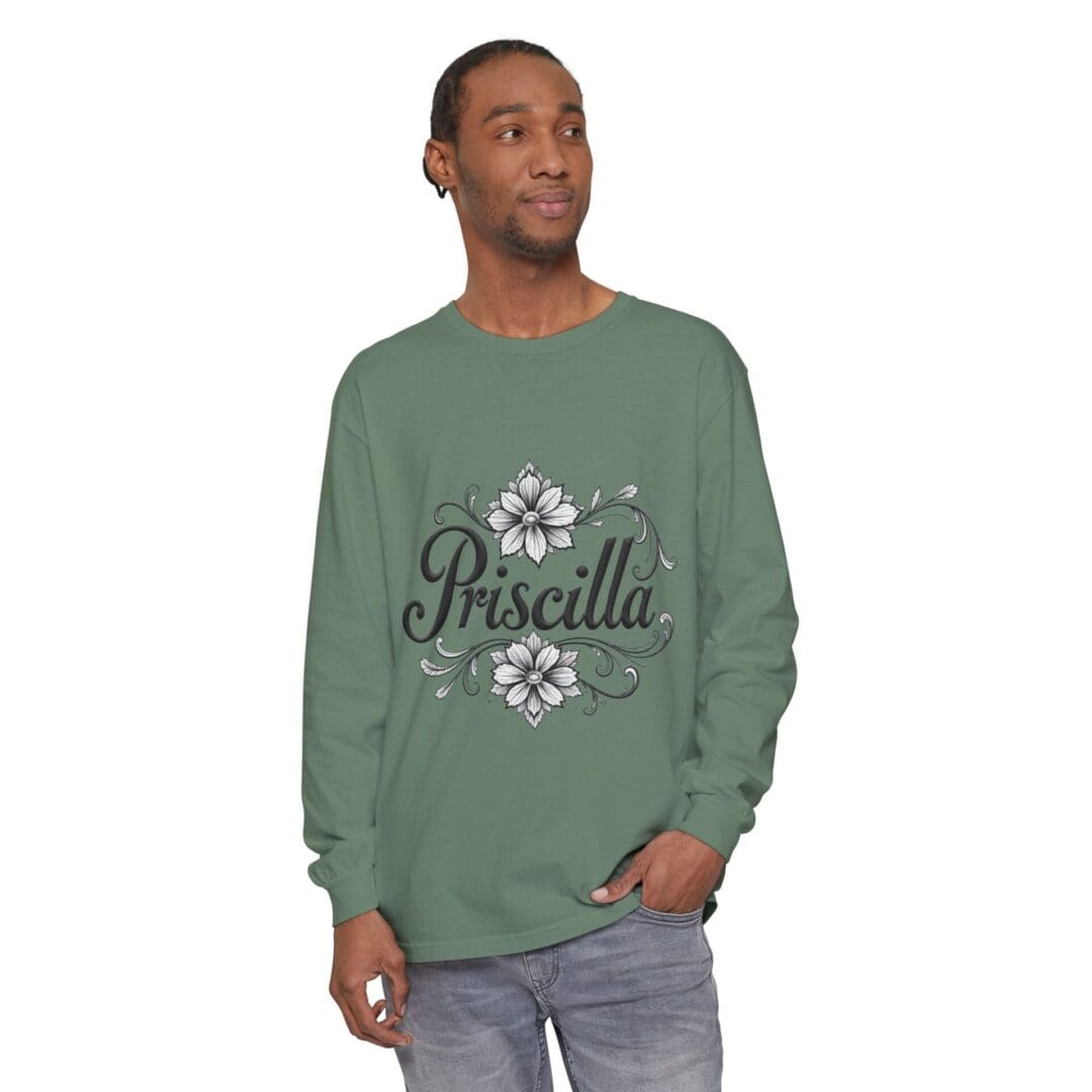 Man wearing a green sweatshirt with the name 'Priscilla' and floral designs.