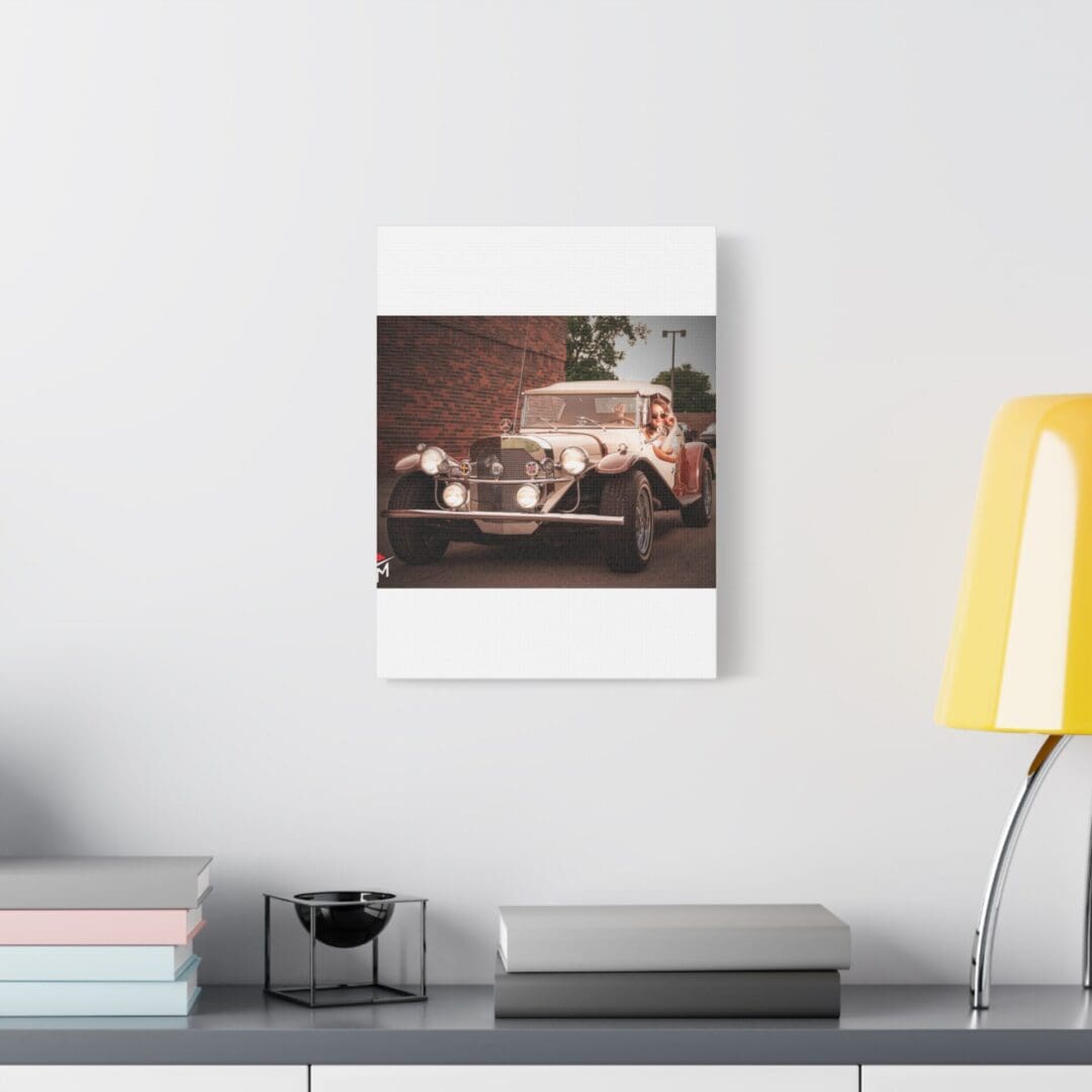 Vintage car photo framed on a minimalist wall beside a yellow lamp.