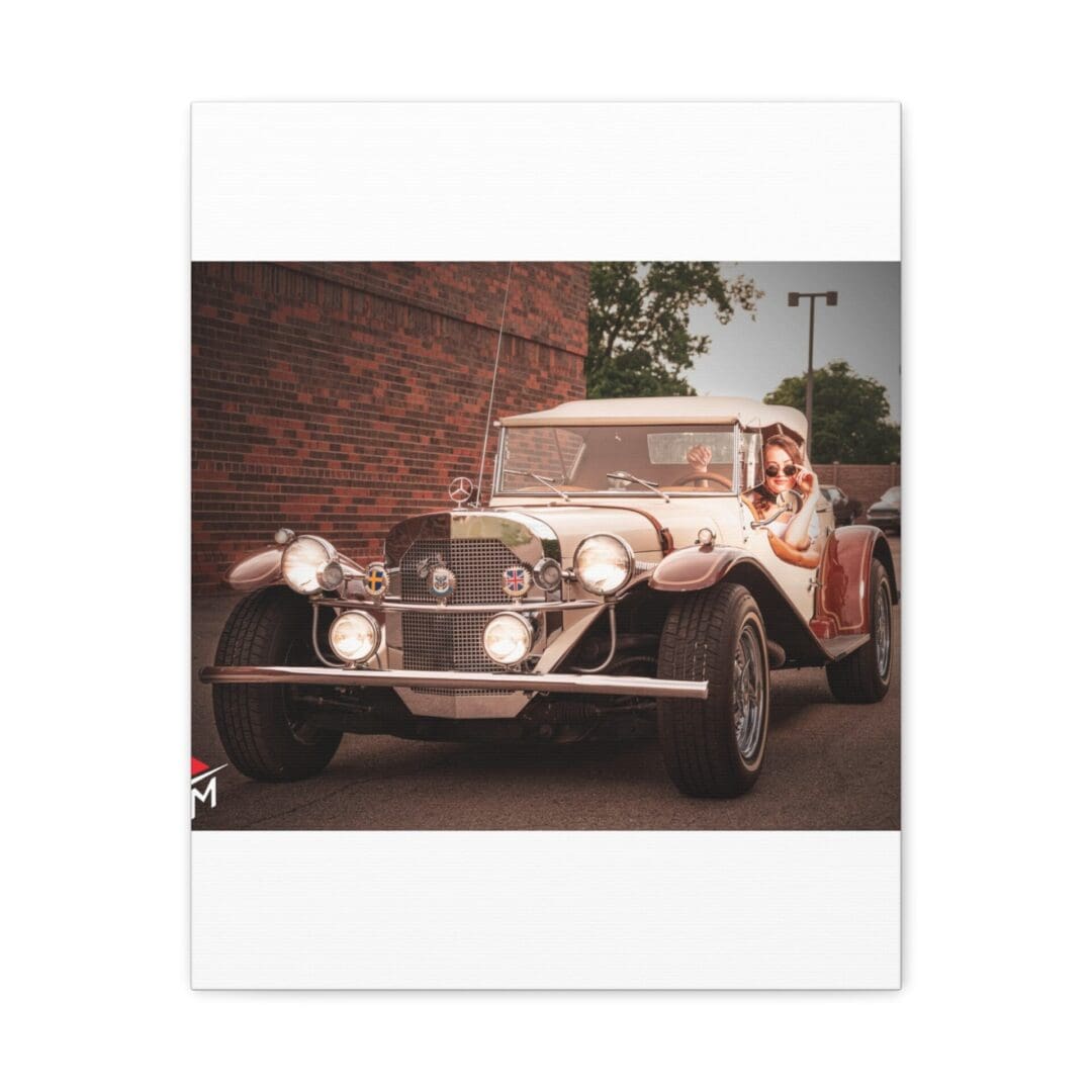 Vintage classic car parked on a street near a brick wall.