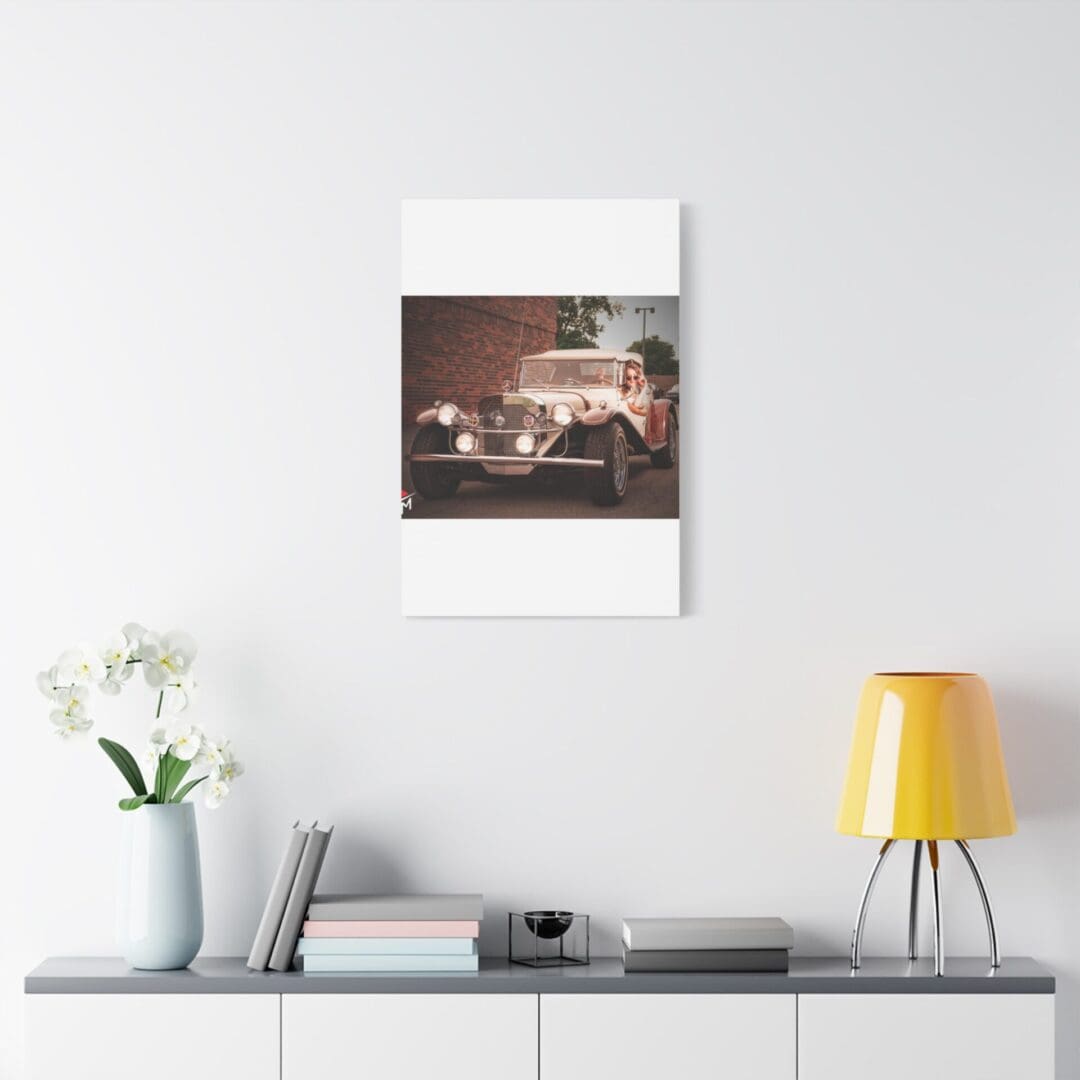 A cozy, minimalist room with a vintage car photo on the wall.