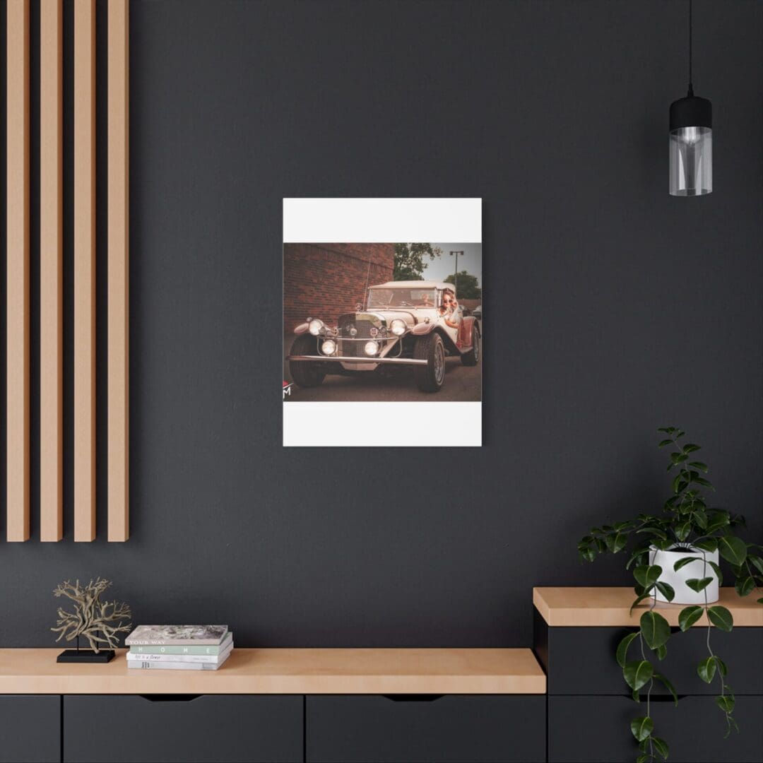 Modern workspace with vintage car poster on dark wall.