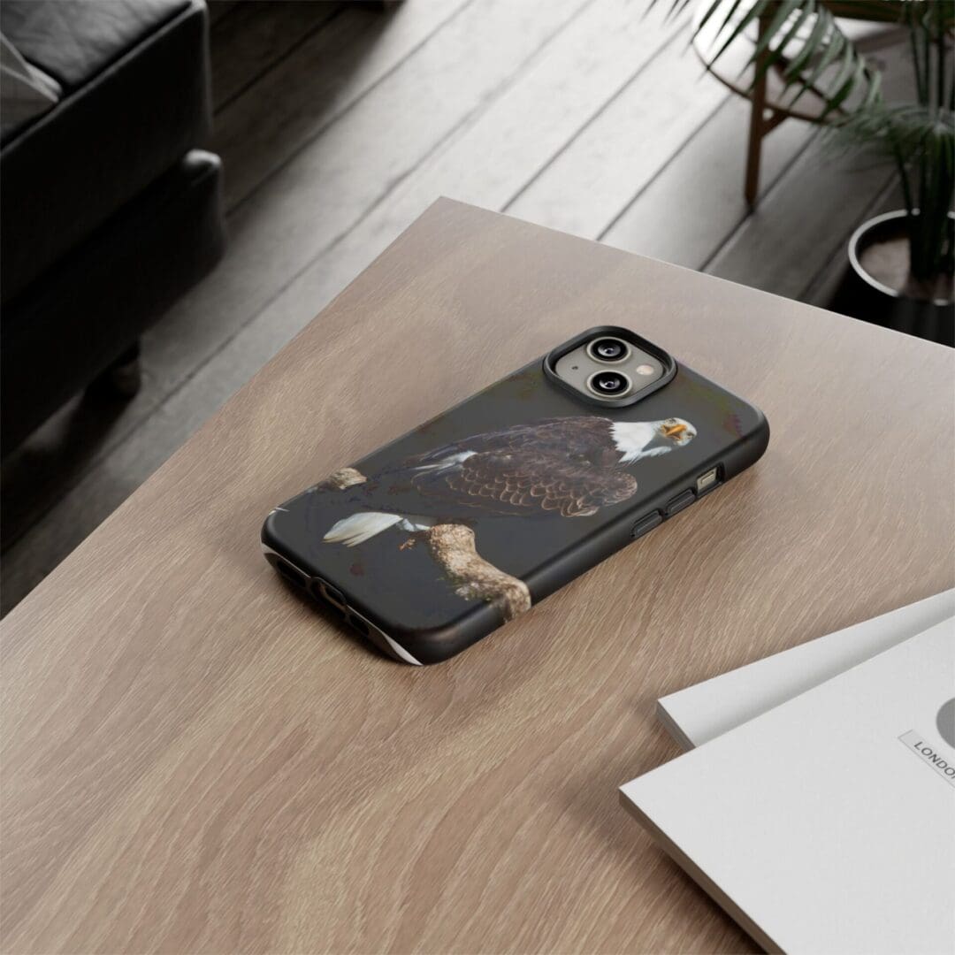 A smartphone with a black marble-patterned case on a wooden table.