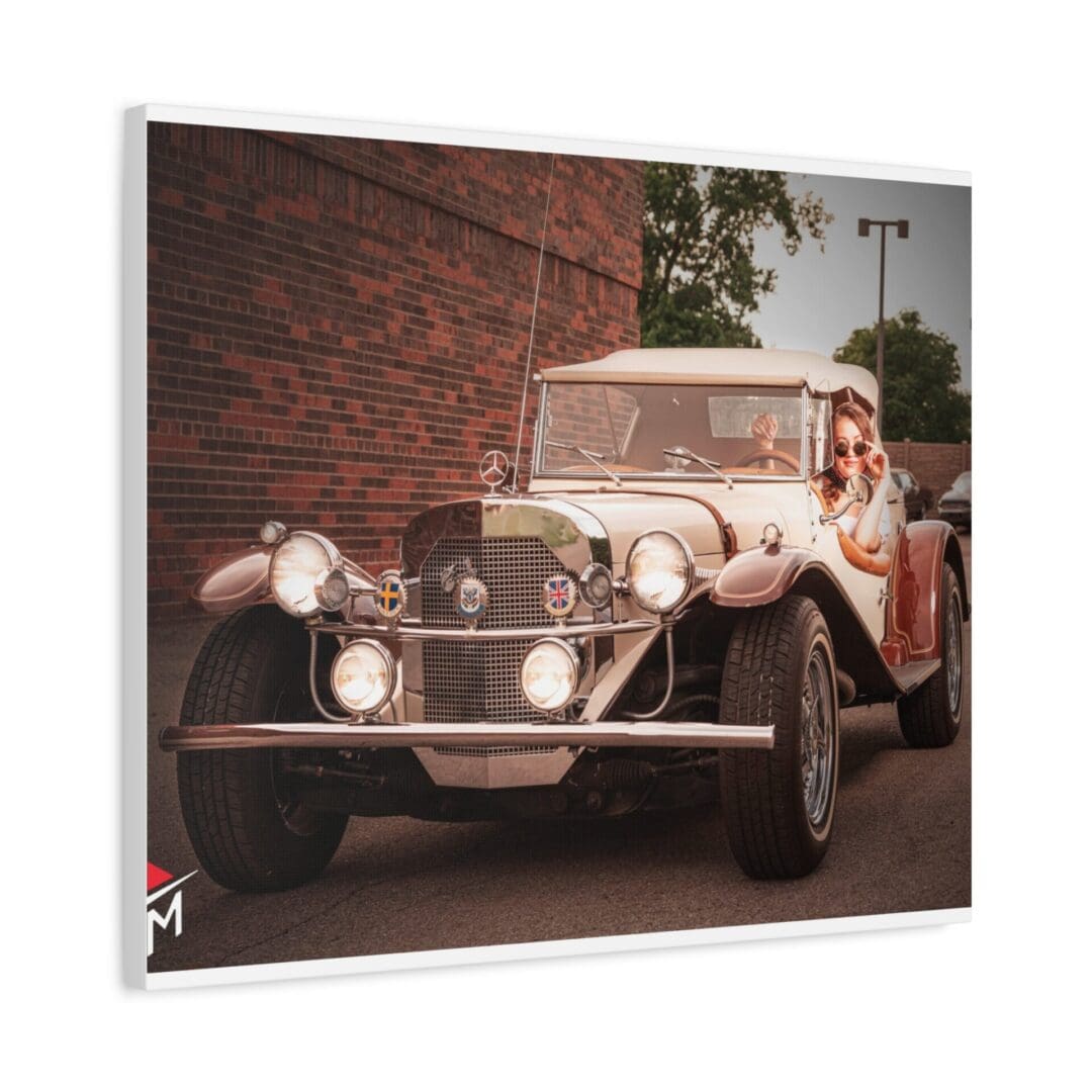 Vintage car with a woman posing beside it in a sunny outdoor setting.
