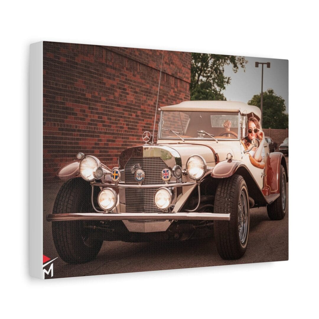 Vintage car parked on a street with a brick wall background.