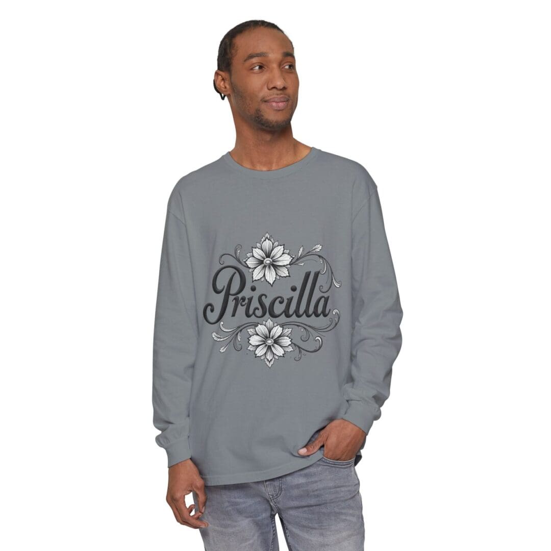 Man wearing a gray sweatshirt with floral design and 'Priscilla' text.