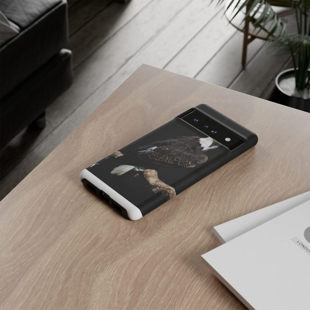 A black book titled 'The Secret' on a wooden table beside documents.