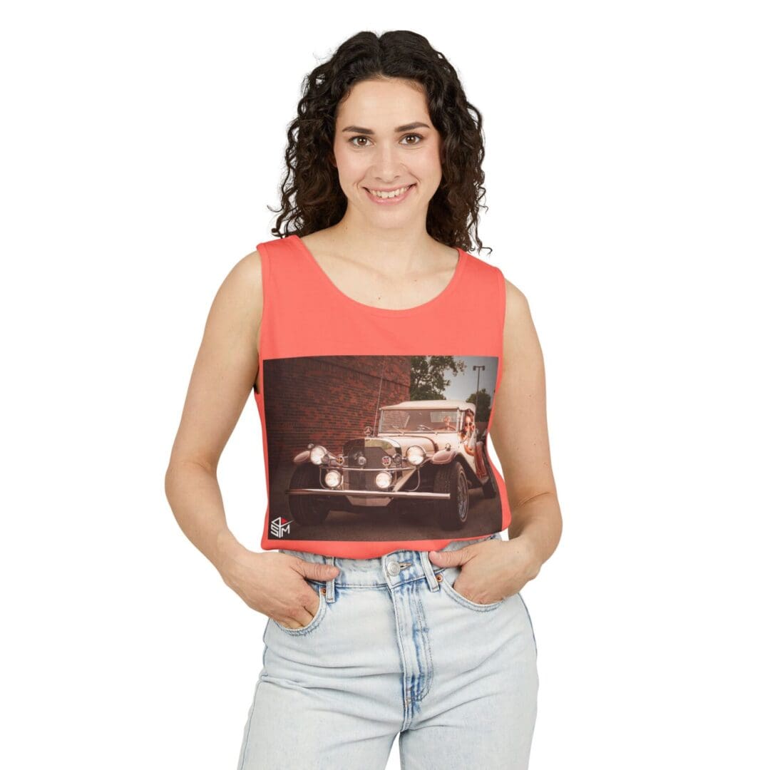 Woman holding a vintage photo of a car at night.
