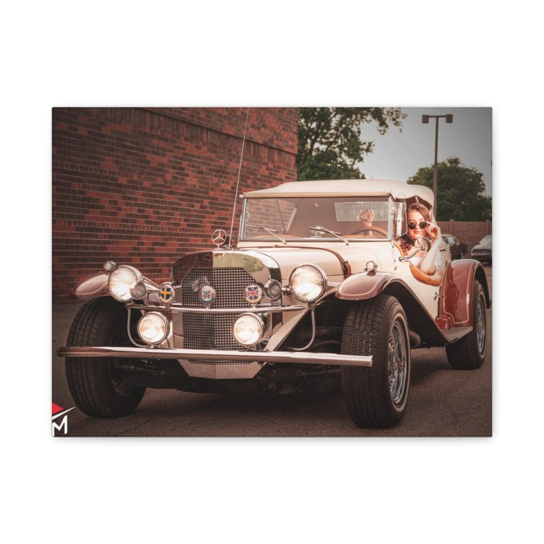 A vintage car with a driver in a classic setting.