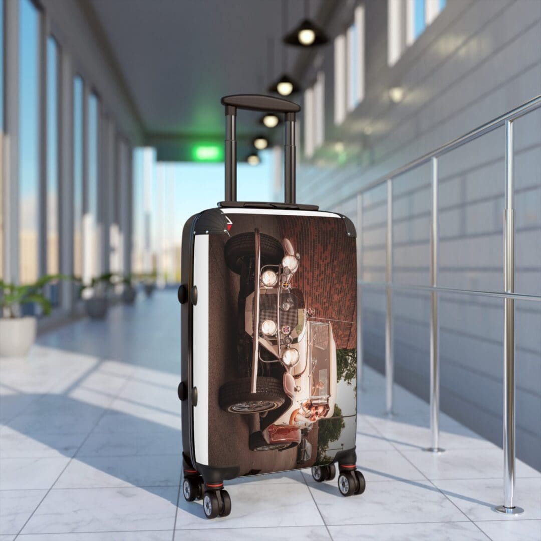 A reflective suitcase in a modern airport terminal with a blurred person.