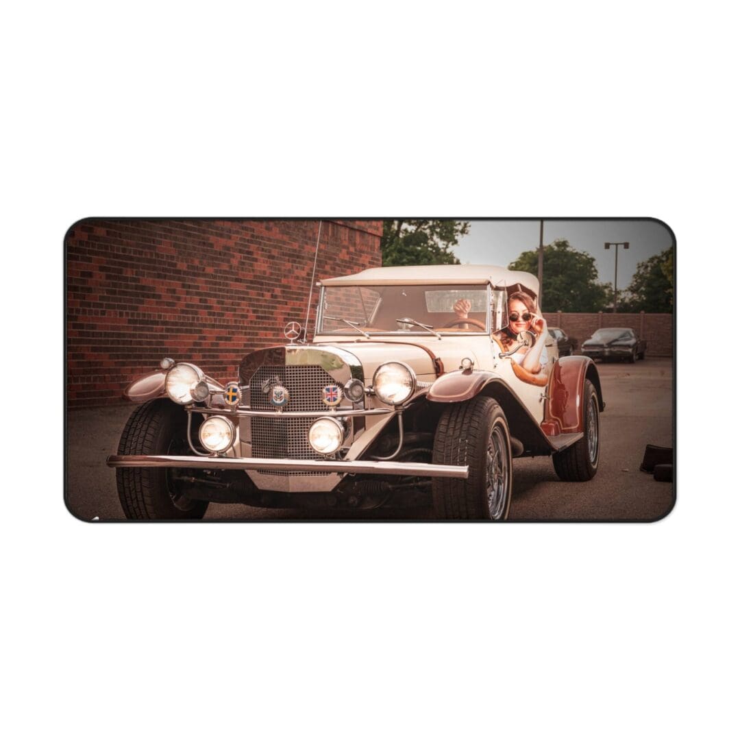 Vintage white convertible car driving on a street with brick walls.