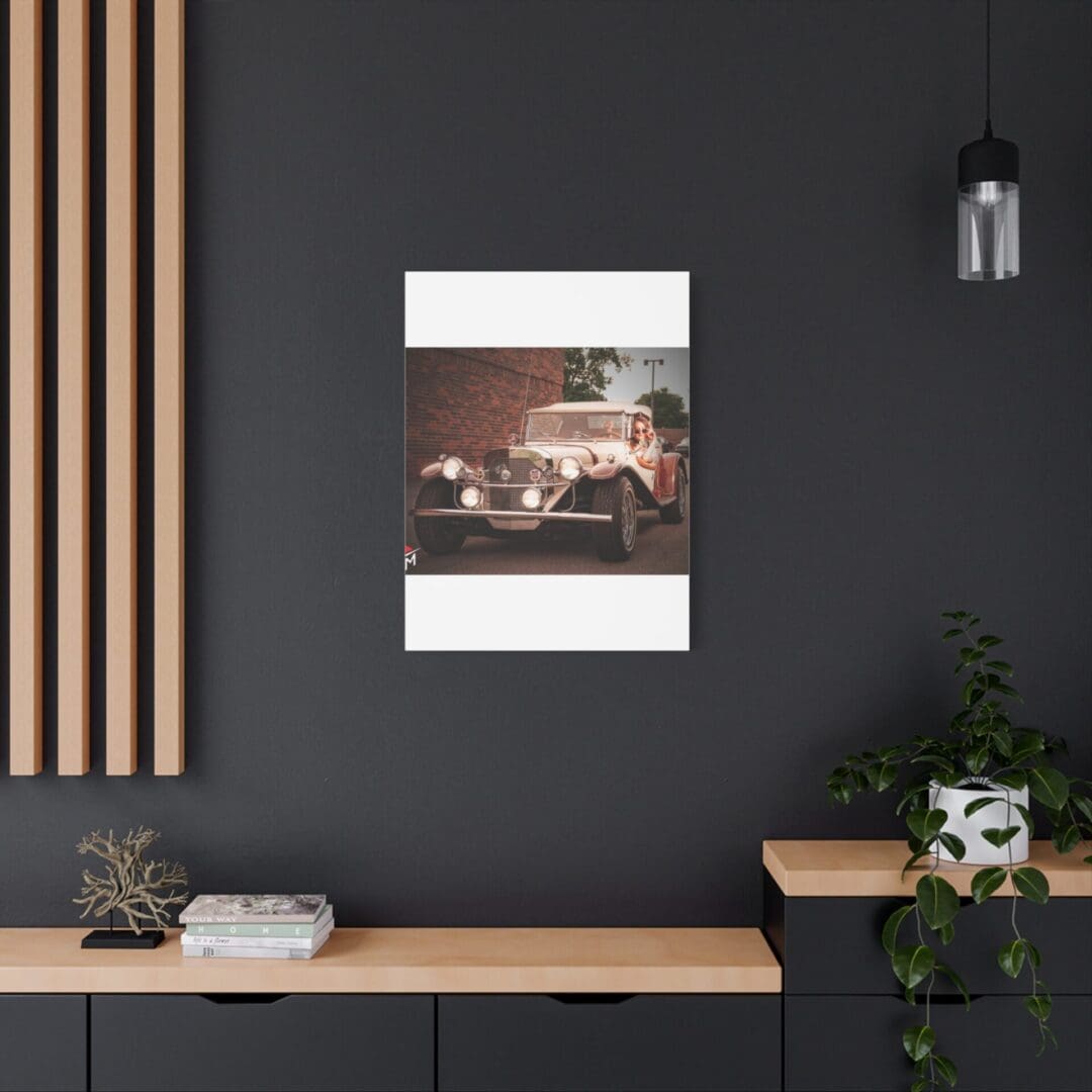 Modern workspace with a vintage car poster on a dark wall.