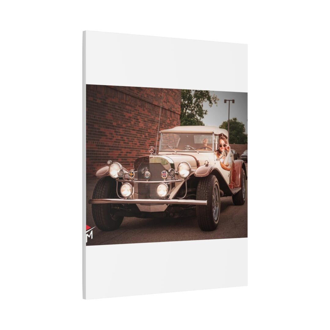 A vintage car parked on a street near a brick wall with greenery.