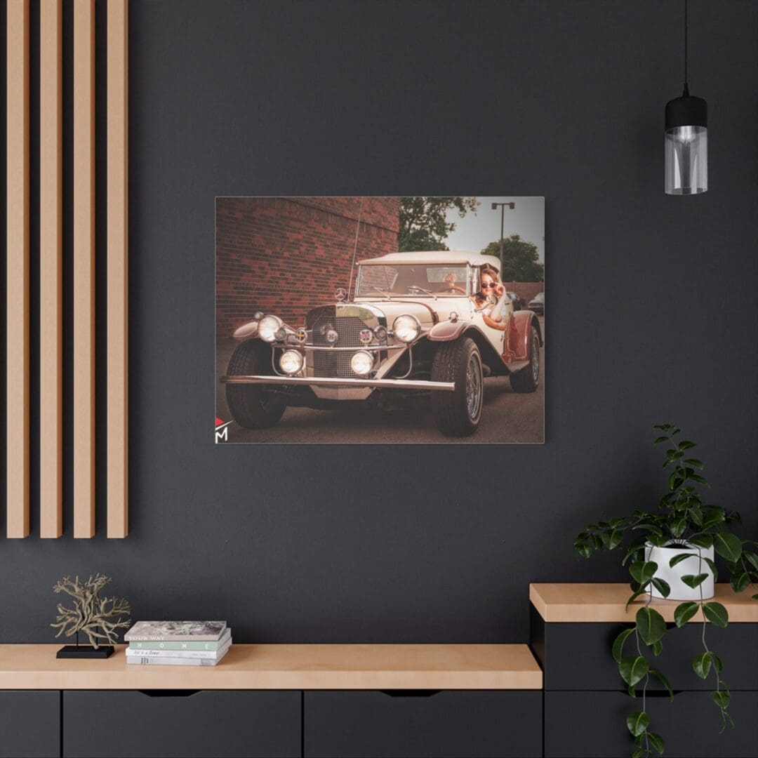 Vintage car photo framed on modern office wall with plants and decor.