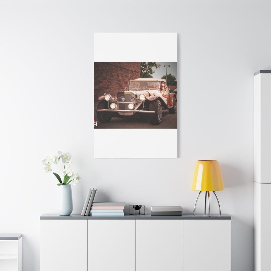 Modern living room with a stylish car poster above a white cabinet.