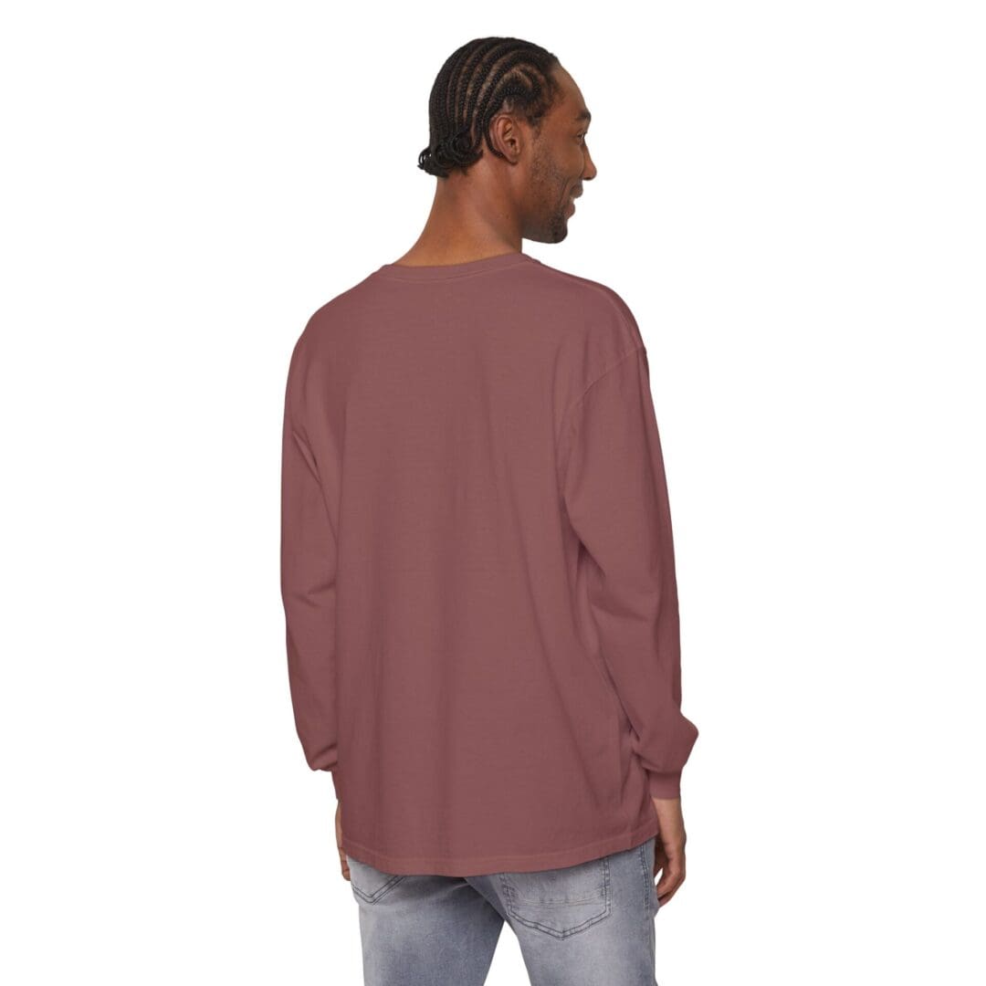 Man wearing a loose maroon long-sleeve shirt and jeans, seen from behind.